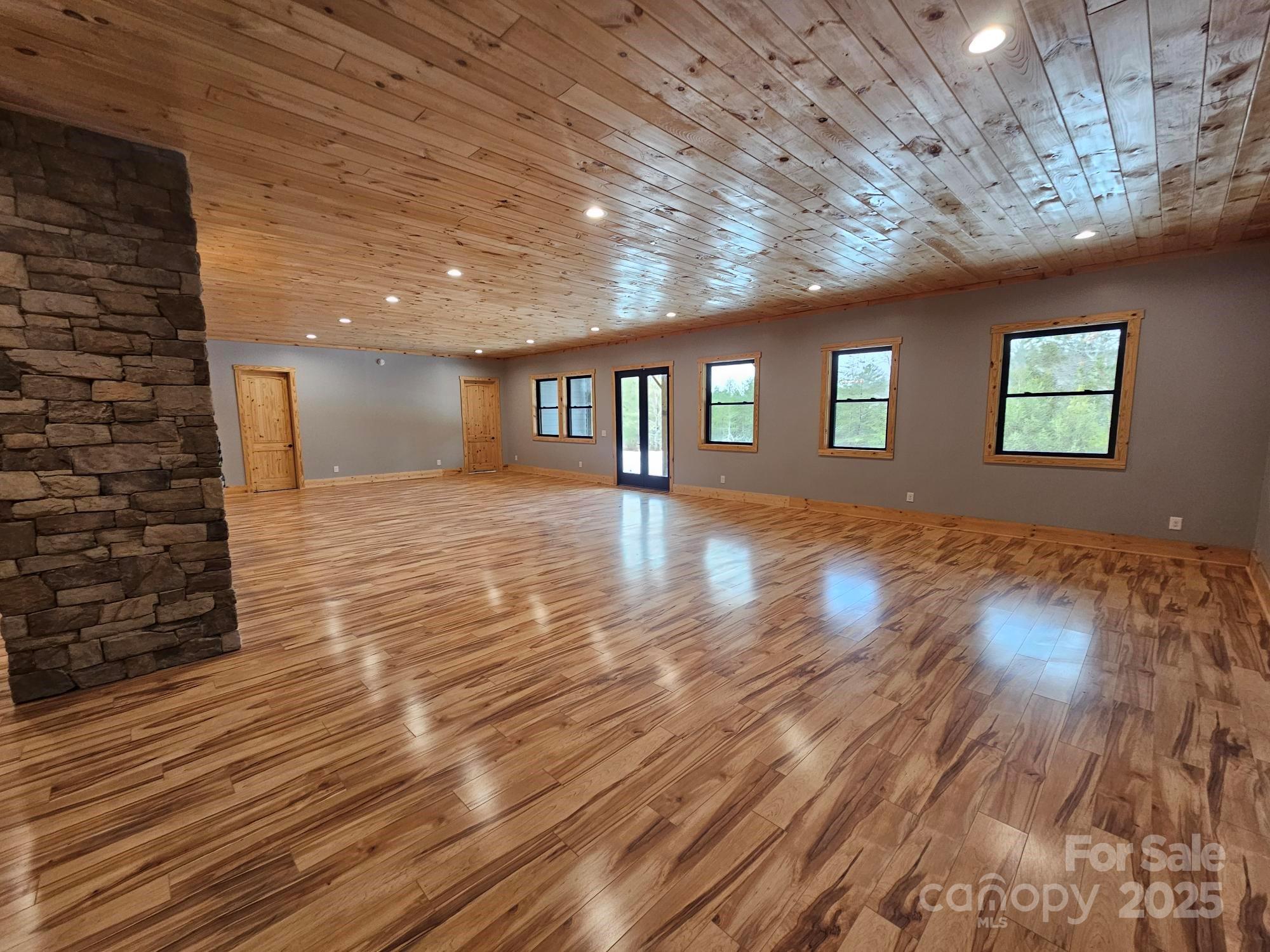 1076 Table View Drive, Unit 55 Morganton, NC 28655 - Photo 14 of 33 a view of an empty room with wooden floor and a window