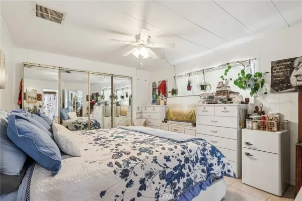 a bed room with a bed and a large mirror