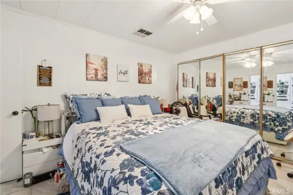 a bed sitting in a bedroom and a chandelier