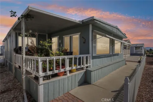 a aerial view of a house with a yard table and chairs