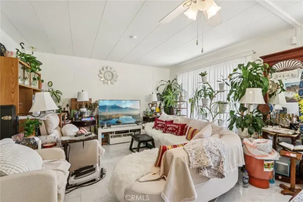 a living room with furniture and a floor to ceiling window