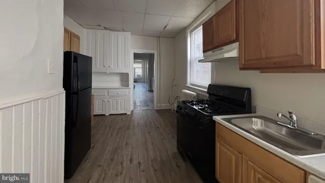 a kitchen with a refrigerator stove and sink
