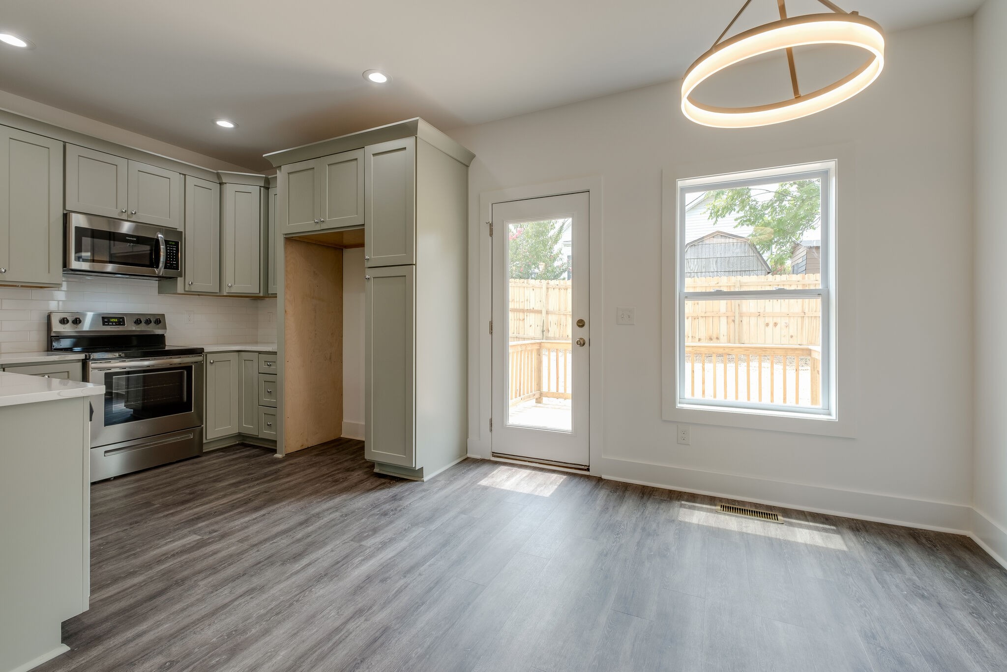 4341 Goins Road Nashville, TN 37211 - Photo 7 of 28 a kitchen with stainless steel appliances granite countertop a refrigerator a sink a stove a microwave and wooden floor
