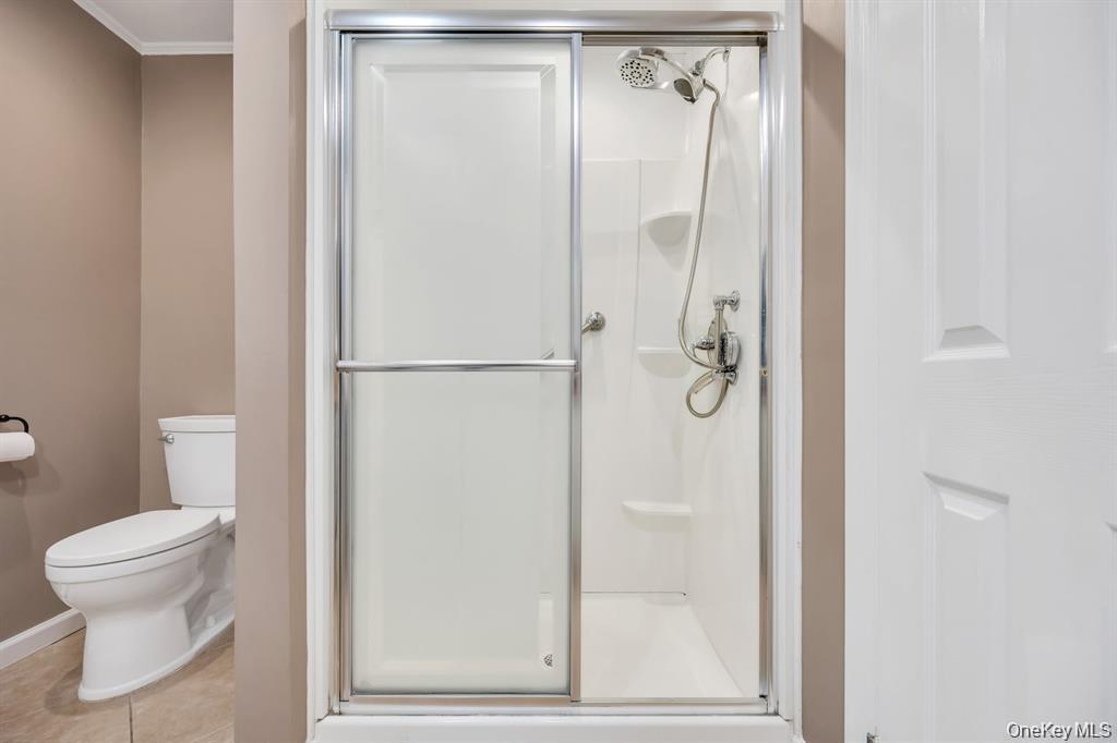 10 Ramblewood Road Ridge, NY 11961 - Photo 34 of 39 a bathroom with a glass shower door