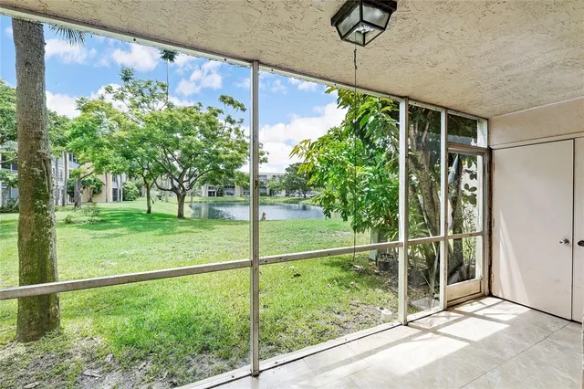 a view of a yard with potted plants