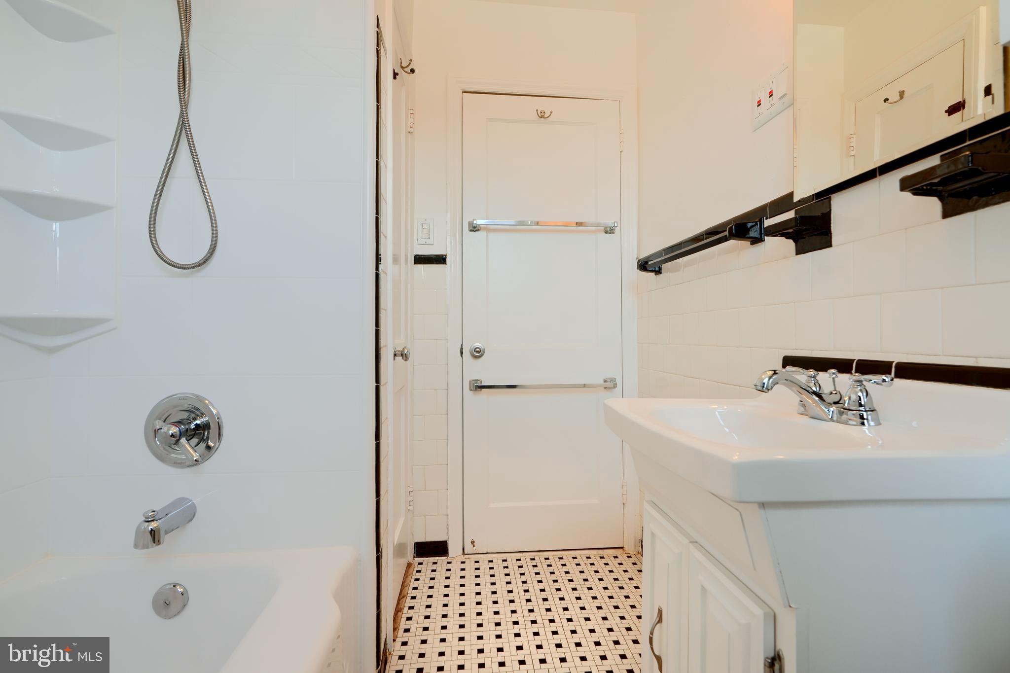 1852 Edgewood Road Towson, MD 21286 - Photo 15 of 31 a bathroom with a sink a mirror and a shower
