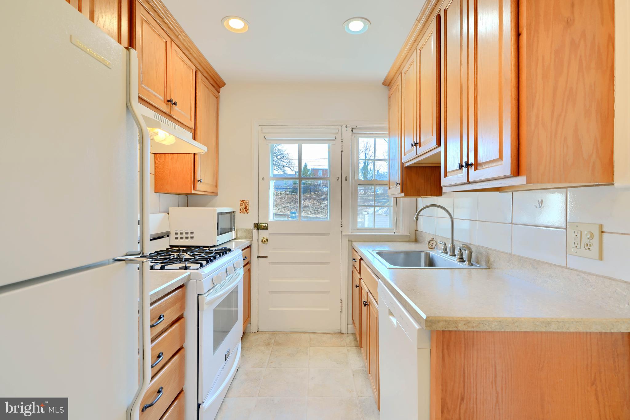 1852 Edgewood Road Towson, MD 21286 - Photo 10 of 31 a kitchen with stainless steel appliances granite countertop a sink a stove and a refrigerator