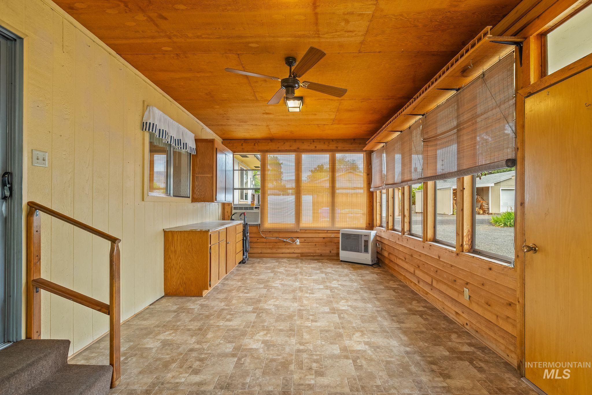 1721 3rd Street Lewiston, ID 83501 - Photo 41 of 45 Enclosed sunroom featuring wood-finish flooring, wood plank ceiling, and a ceiling fan with integrated lighting