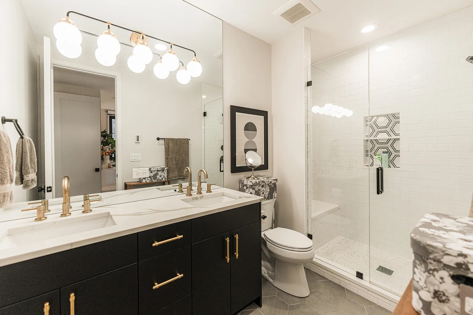 1703 West Chicago Avenue, Unit 4 Chicago, IL 60622 - Photo 11 of 11 a bathroom with a double vanity sink toilet mirror and shower