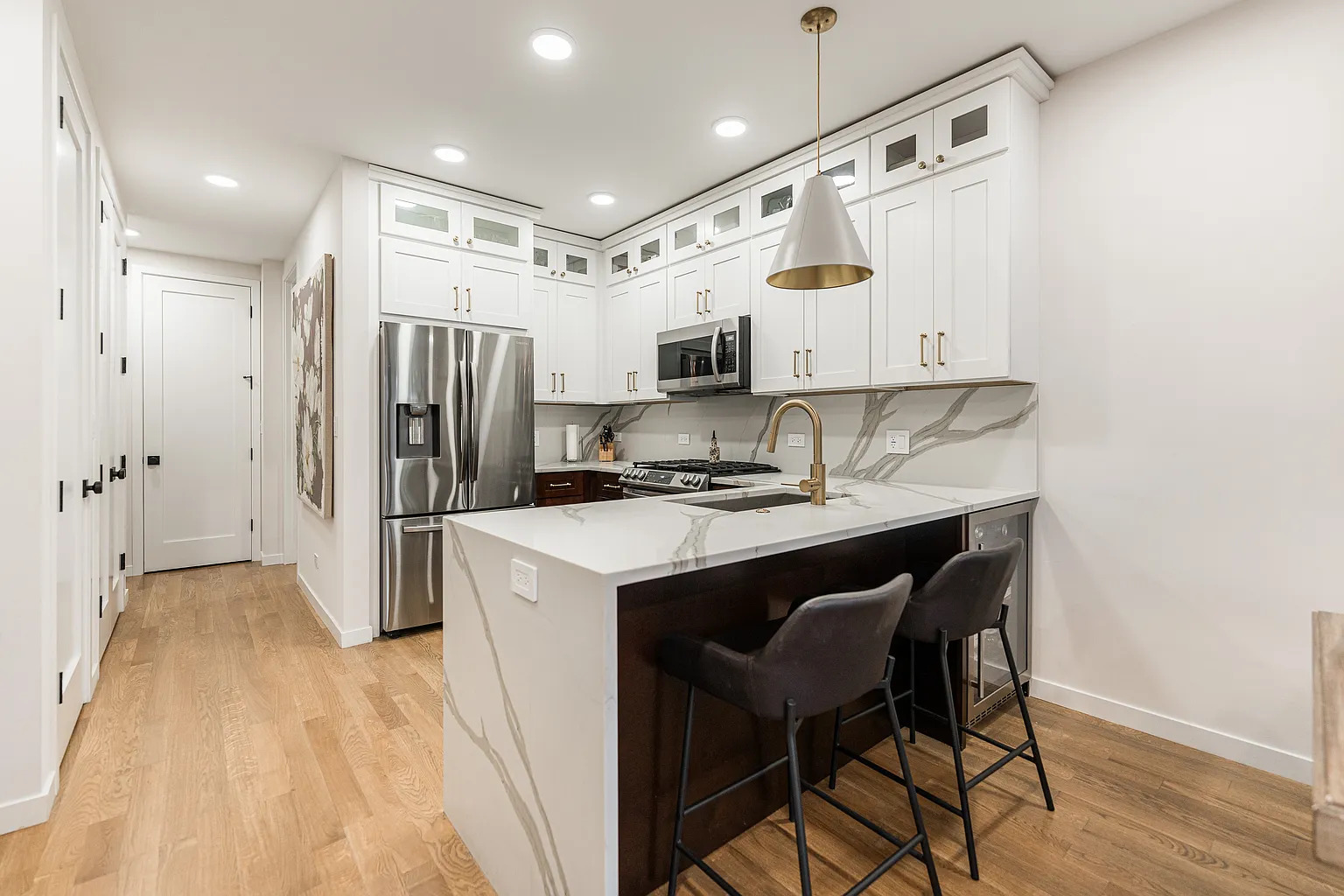1703 West Chicago Avenue, Unit 4 Chicago, IL 60622 - Photo 5 of 11 a kitchen with stainless steel appliances a stove a refrigerator and a sink