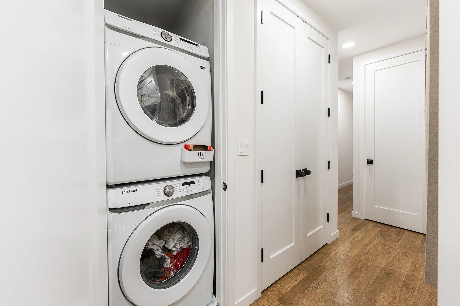 1703 West Chicago Avenue, Unit 4 Chicago, IL 60622 - Photo 7 of 11 a view of a hallway with washer and dryer