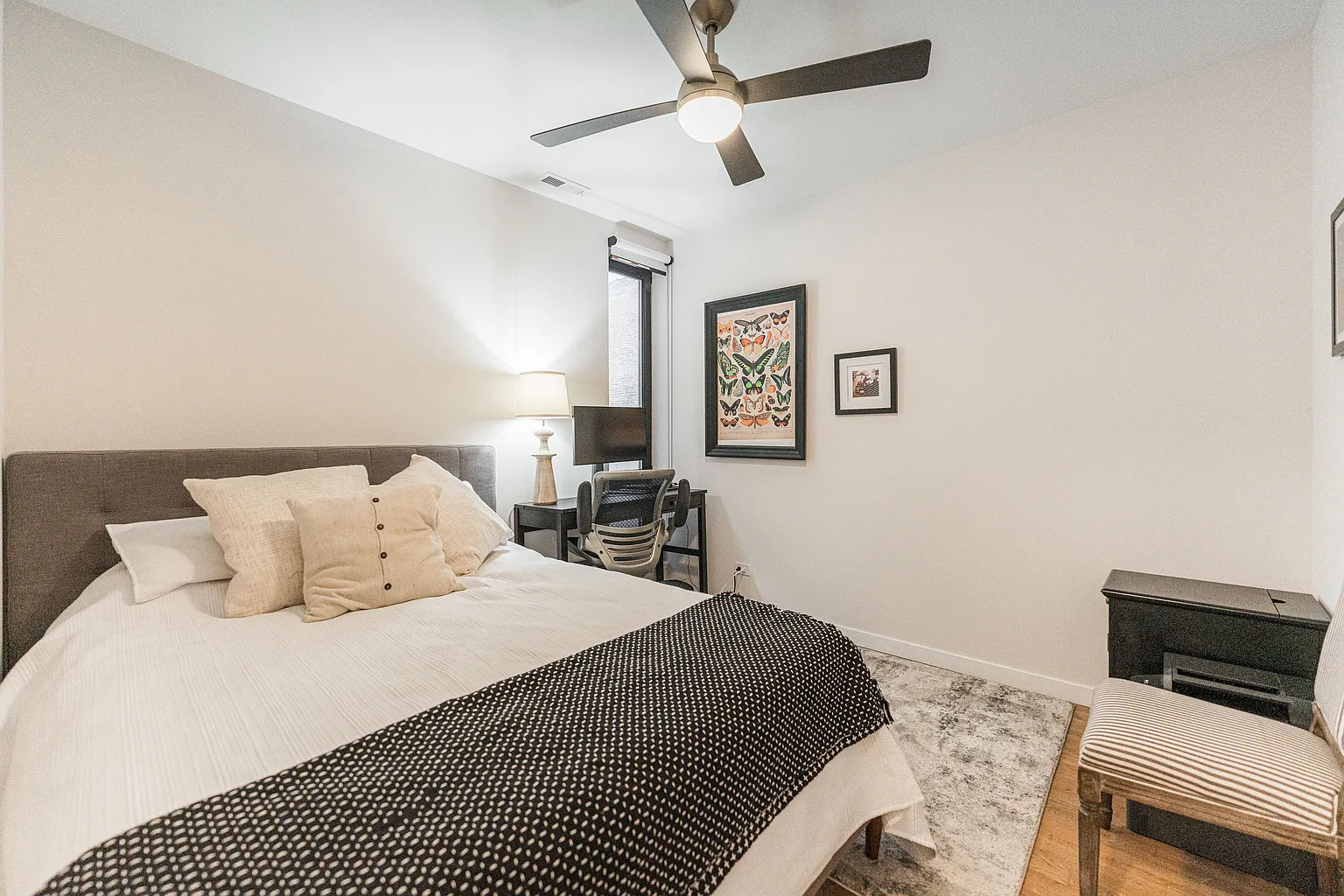 1703 West Chicago Avenue, Unit 4 Chicago, IL 60622 - Photo 9 of 11 a bedroom with a bed and a tv