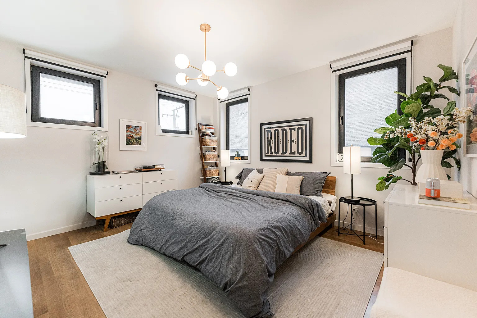 1703 West Chicago Avenue, Unit 4 Chicago, IL 60622 - Photo 10 of 11 a spacious bedroom with a bed and a chandelier