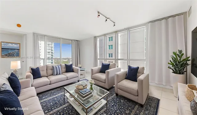 a living room with furniture potted plant and a window