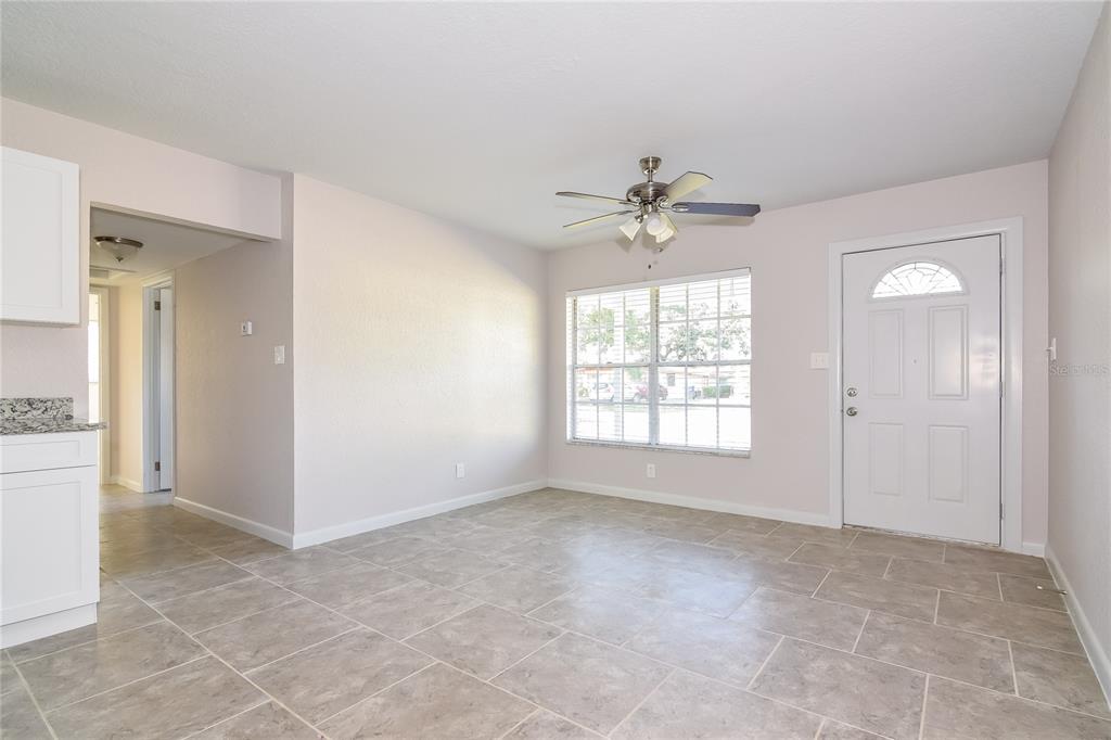 3610 West Leila Avenue Tampa, FL 33611 - Photo 2 of 15 an empty room with chandelier fan and windows