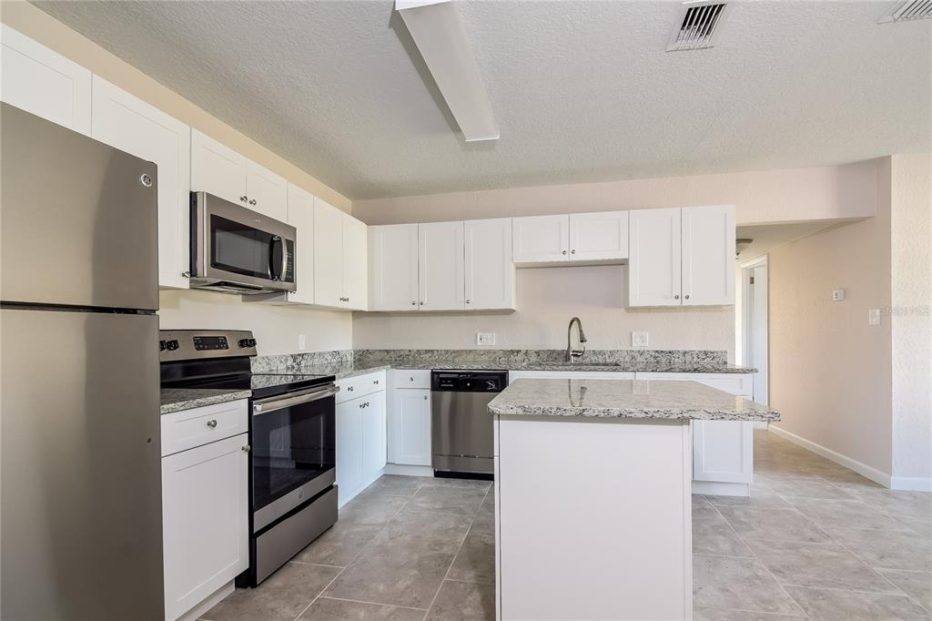 3610 West Leila Avenue Tampa, FL 33611 - Photo 4 of 15 a kitchen with a sink stove and refrigerator