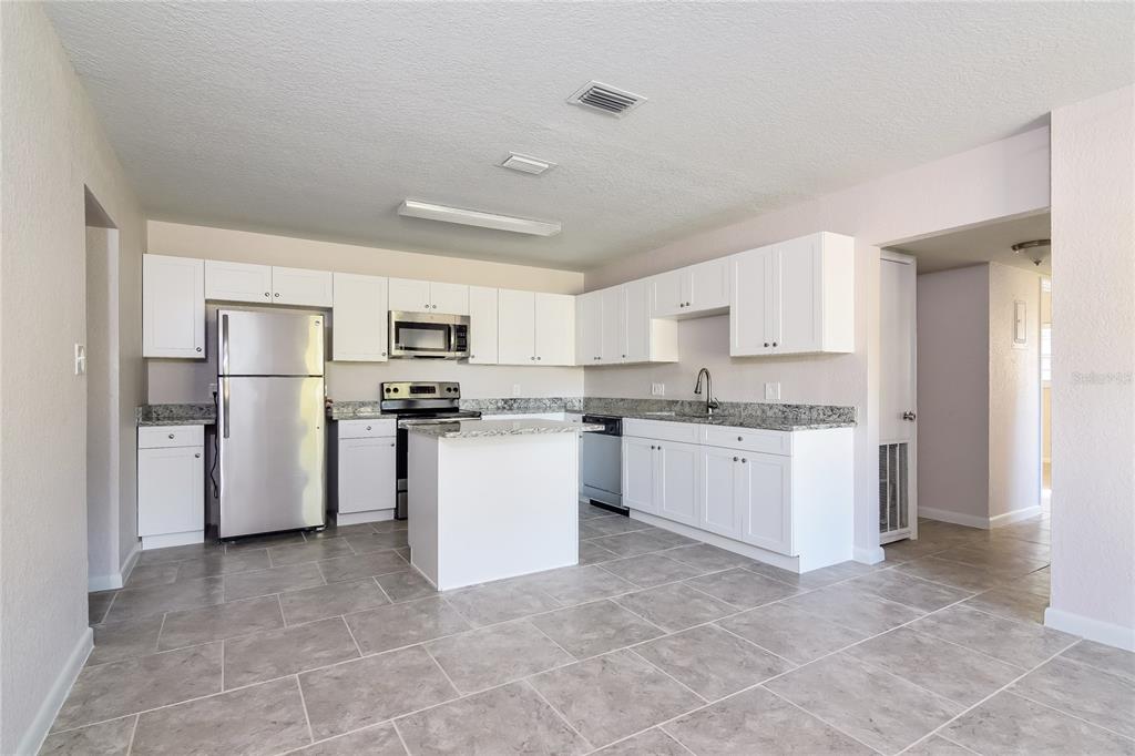 3610 West Leila Avenue Tampa, FL 33611 - Photo 6 of 15 a kitchen with refrigerator and cabinets