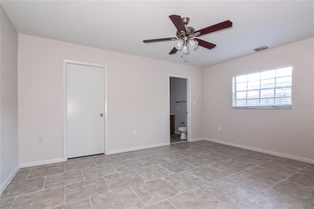3610 West Leila Avenue Tampa, FL 33611 - Photo 7 of 15 a view of an empty room with window and ceiling fan