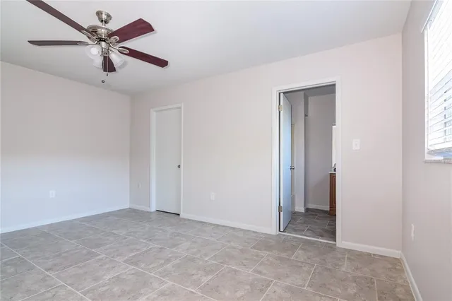 a view of a livingroom with a ceiling fan and window