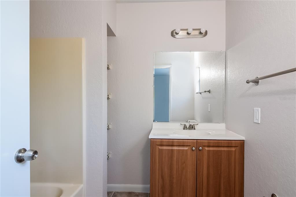 3610 West Leila Avenue Tampa, FL 33611 - Photo 9 of 15 a bathroom with a sink and a mirror