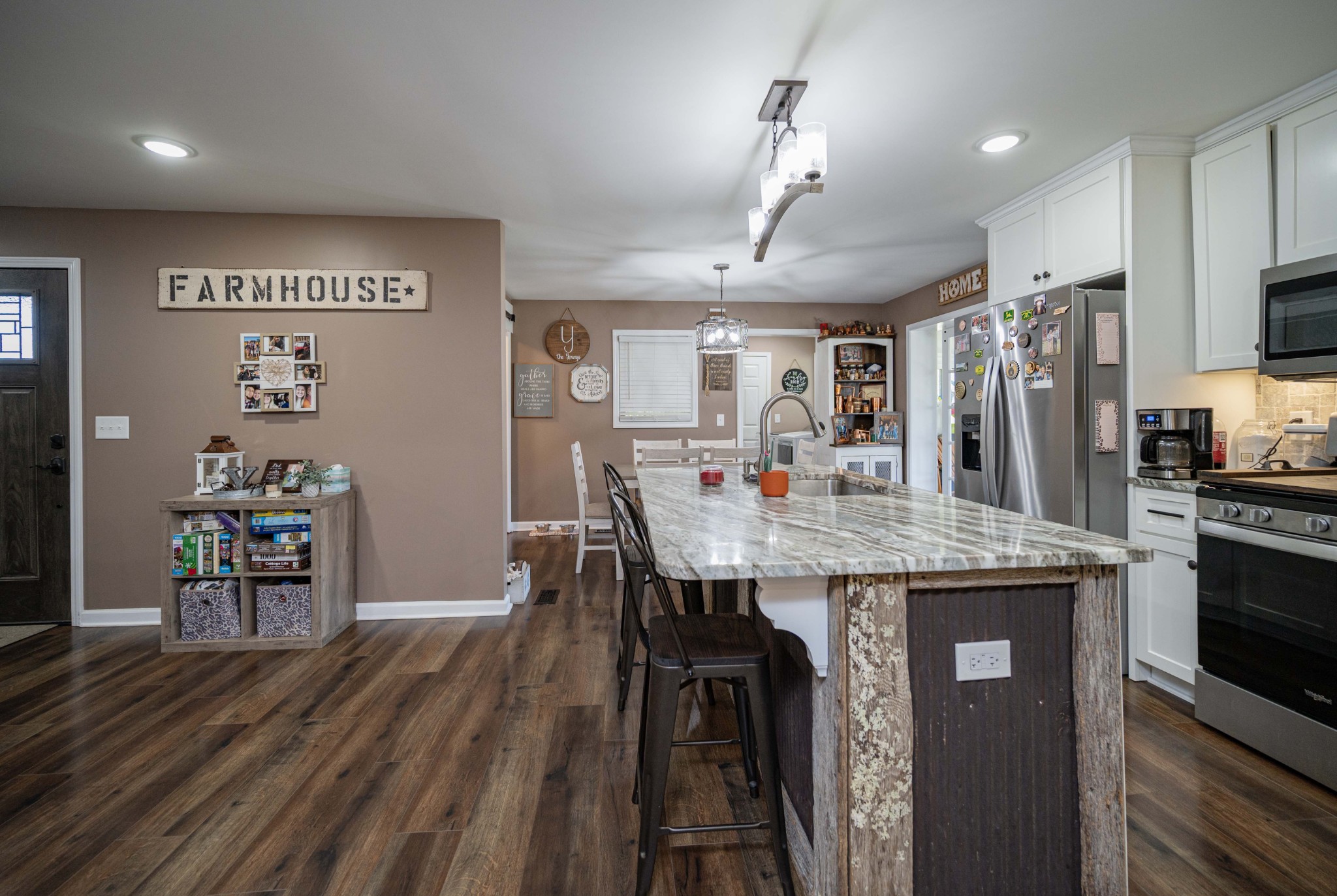 49 Bush Road Bradyville, TN 37026 - Photo 11 of 38 a kitchen with granite countertop a table chairs stove and refrigerator