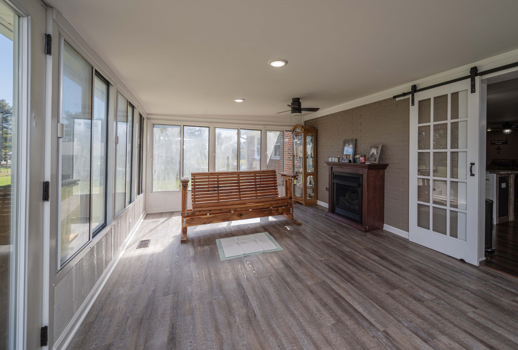 49 Bush Road Bradyville, TN 37026 - Photo 25 of 38 a hallway with wooden floor fireplace and windows