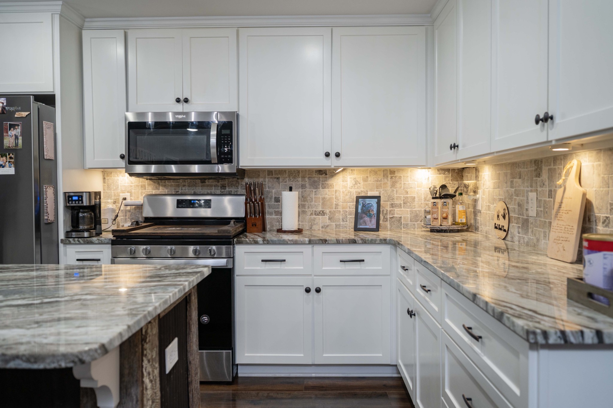 49 Bush Road Bradyville, TN 37026 - Photo 10 of 38 a kitchen with stainless steel appliances granite countertop a sink a stove and a microwave
