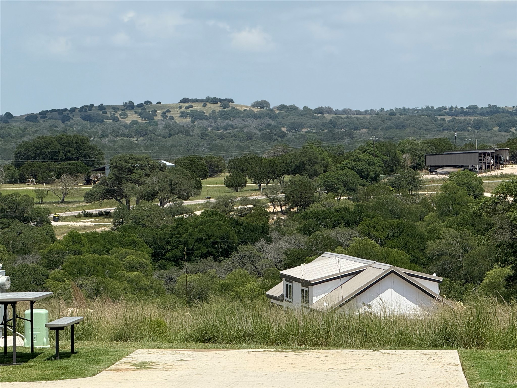5386 Ranch Road 1376, Unit 210 Fredericksburg, TX 78624 - Photo 4 of 13 a view of a terrace with yard and mountain view in back