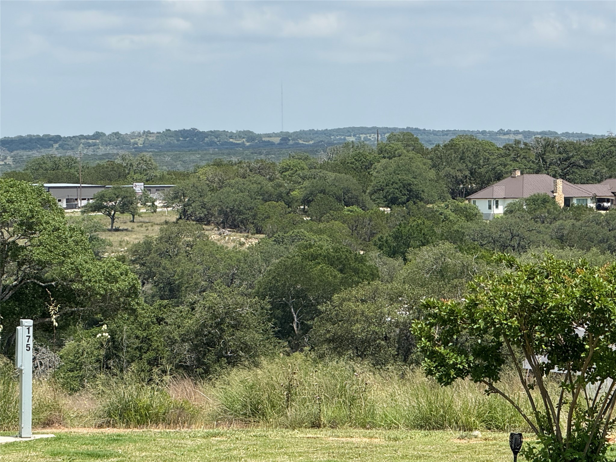 5386 Ranch Road 1376, Unit 210 Fredericksburg, TX 78624 - Photo 5 of 13 an aerial view of residential houses with outdoor space and trees