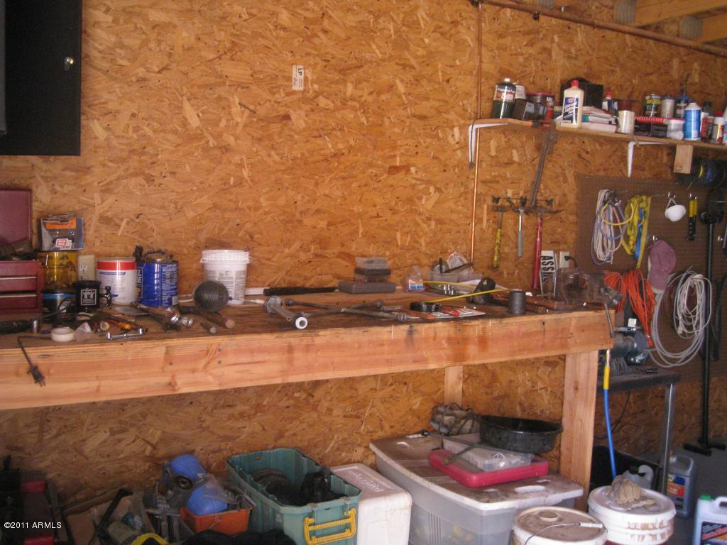3130 South Olmo Road Maricopa, AZ 85139 - Photo 31 of 34 Workshop bench and pegboard
