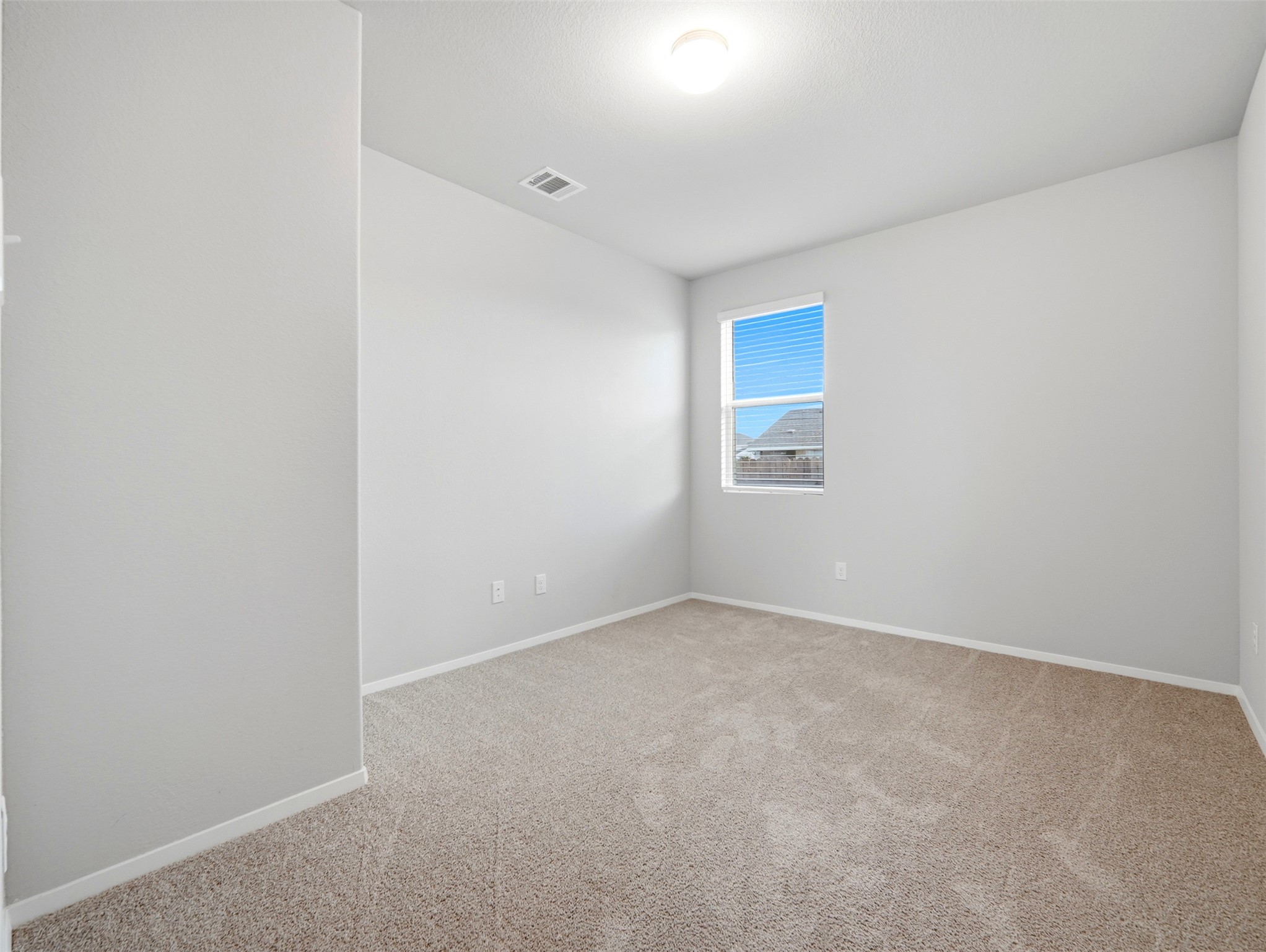60 Bent Trl Lane Georgetown, TX 78628 - Photo 13 of 40 A well-lit, neutral-toned room provides a blank canvas for personalization.