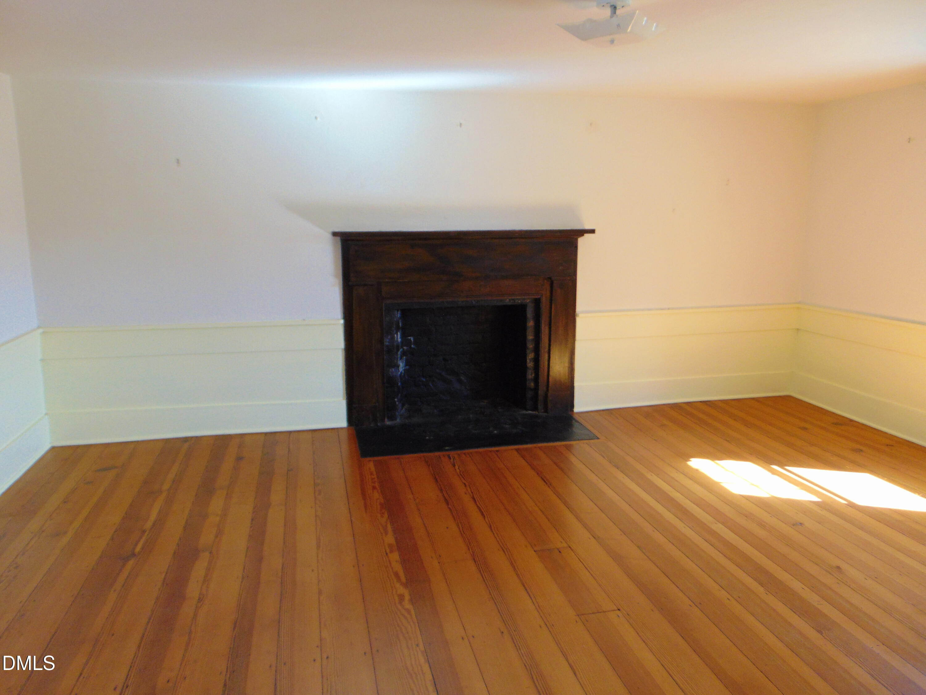 4067 Chewning Road Oxford, NC 27565 - Photo 70 of 82 a view of empty room with wooden floor and fireplace