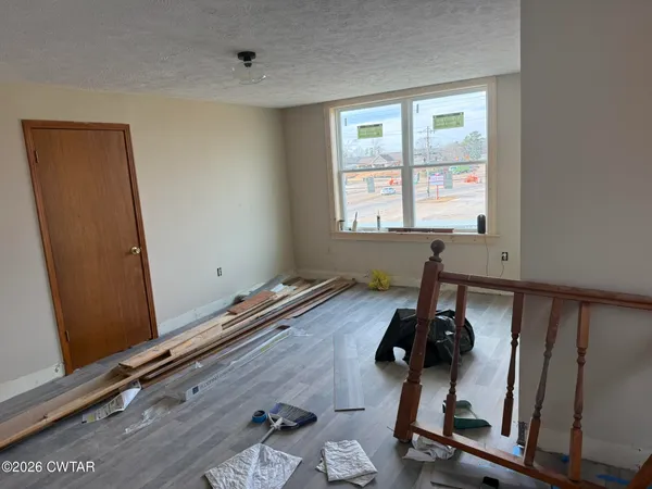 a room with gym equipment and windows