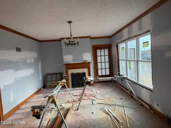 a view of a livingroom with furniture and a fireplace