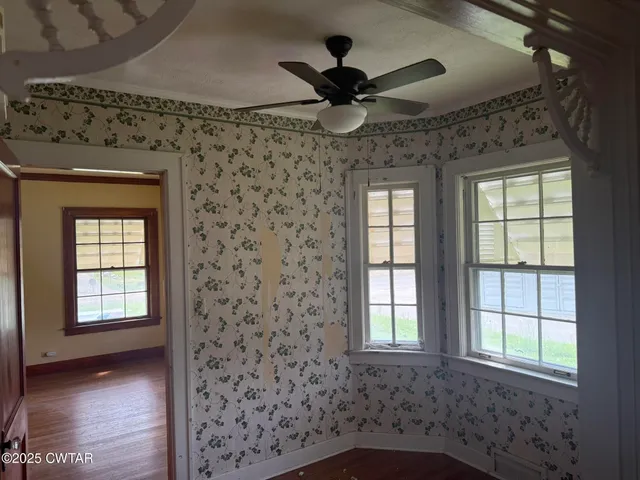 a view of a livingroom with a ceiling fan and window