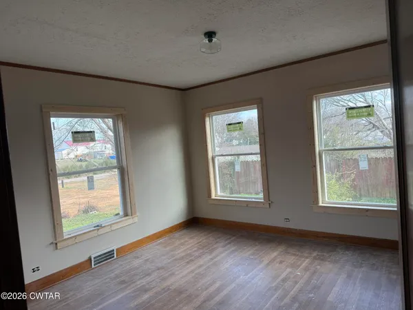 a view of an empty room with a window