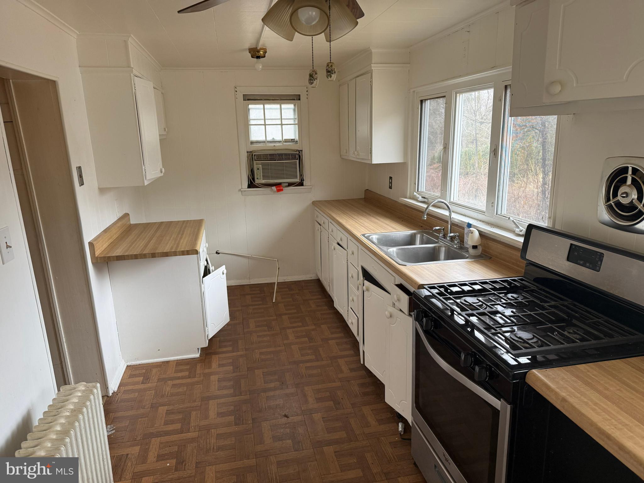 8026 Rider Avenue Towson, MD 21204 - Photo 2 of 29 a kitchen with a stove a sink a refrigerator and windows