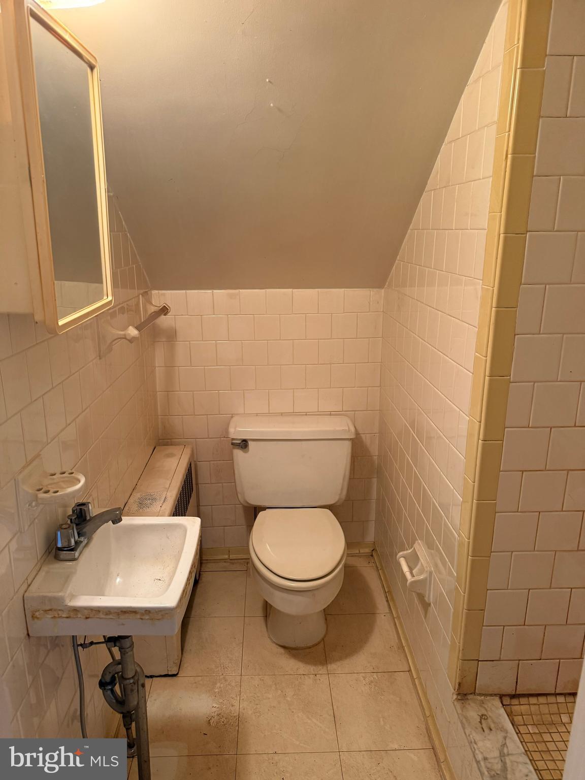 8026 Rider Avenue Towson, MD 21204 - Photo 22 of 29 a bathroom with a toilet a sink and a mirror