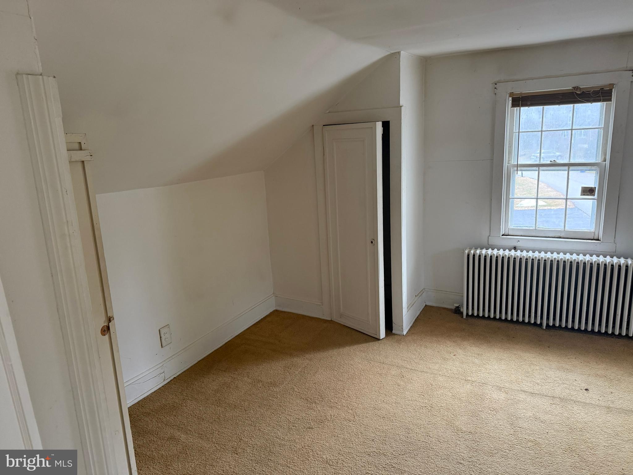 8026 Rider Avenue Towson, MD 21204 - Photo 24 of 29 an empty room with a window and a wooden floor