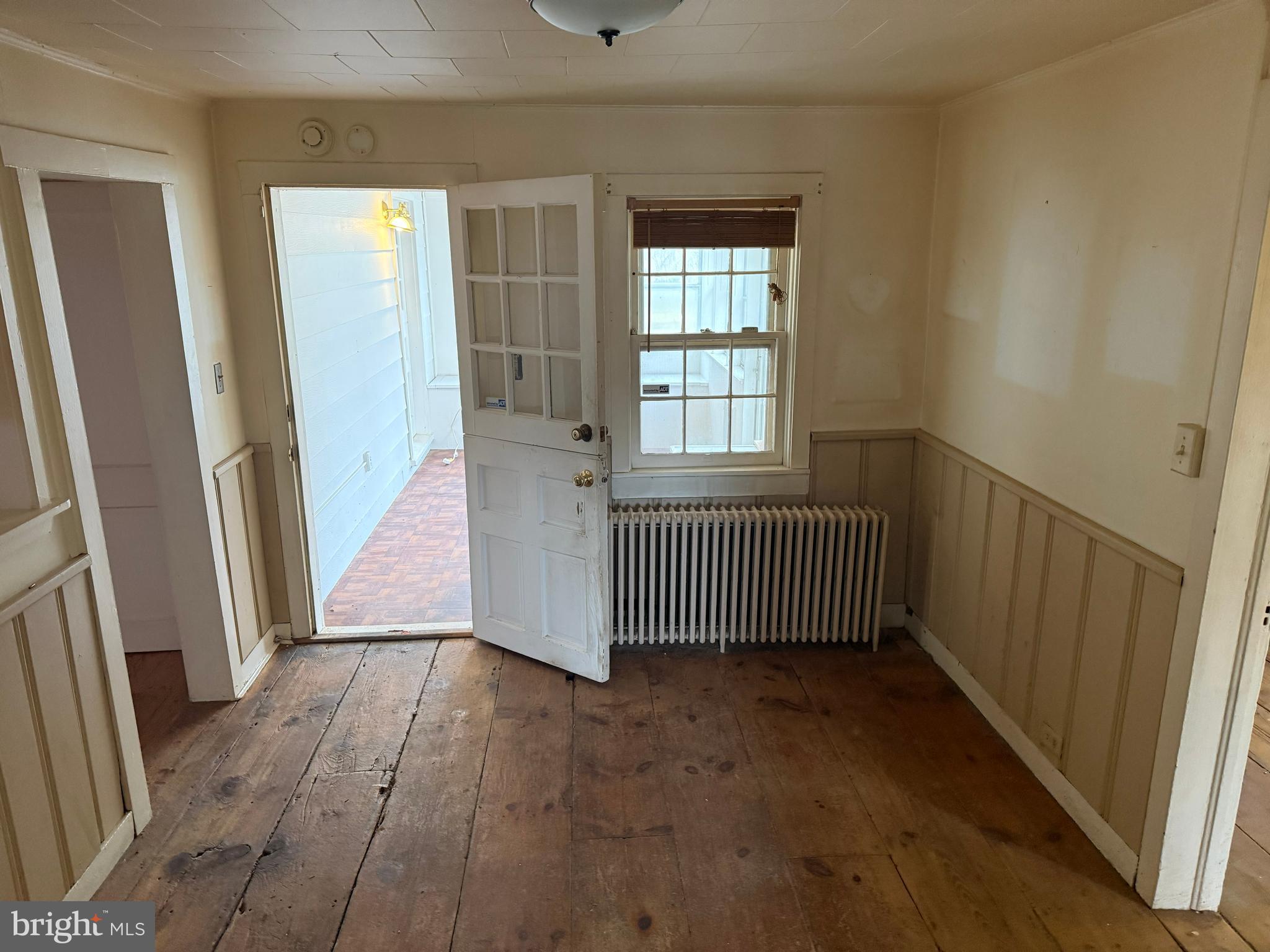 8026 Rider Avenue Towson, MD 21204 - Photo 4 of 29 an empty room with wooden floor and windows