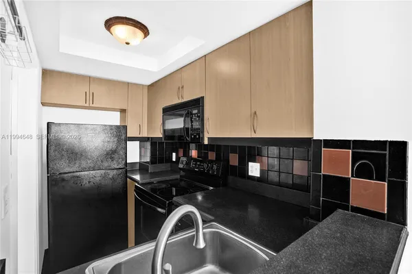 a kitchen with stainless steel appliances granite countertop a stove and a microwave