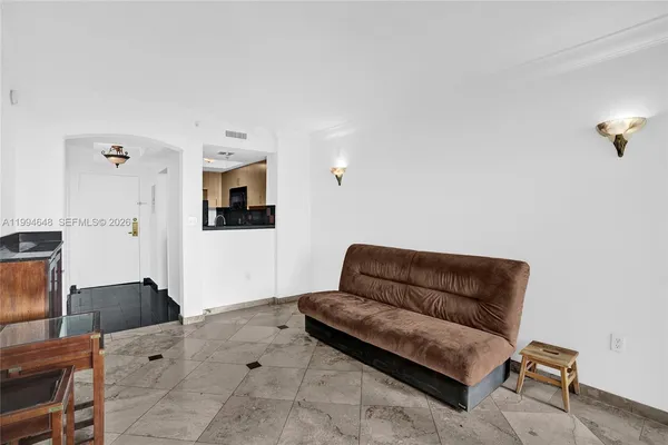 a living room with furniture and a floor to ceiling window