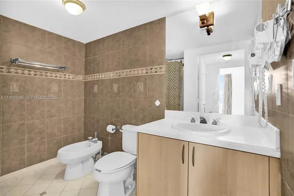 a bedroom with a bed and a chair with the view