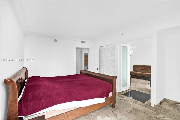 a bed sitting in a bedroom next to a window