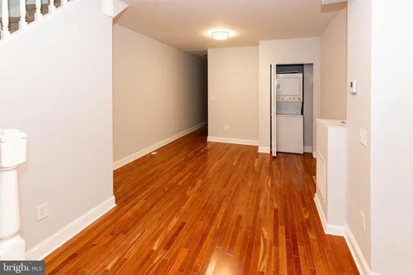 a view of a room with wooden floor