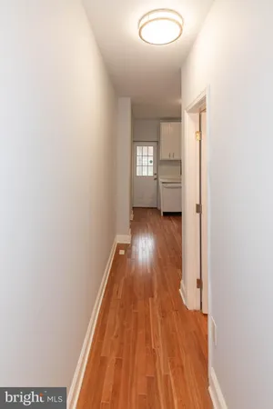 a view of a room with wooden floor and a window