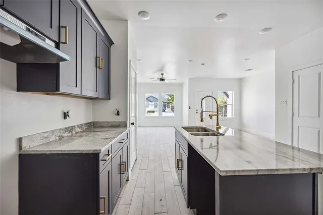 a kitchen with a sink stove and cabinets
