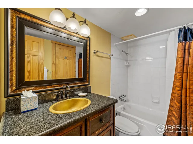 a bathroom with a sink double vanity mirror and a bathtub