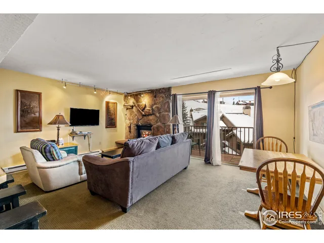 a living room with furniture wooden floor and a flat screen tv