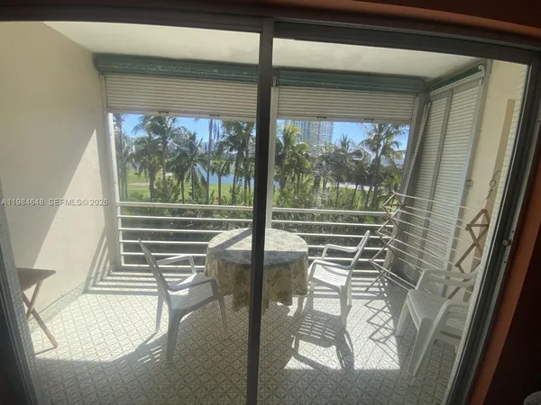 a dining room with furniture and a potted plant